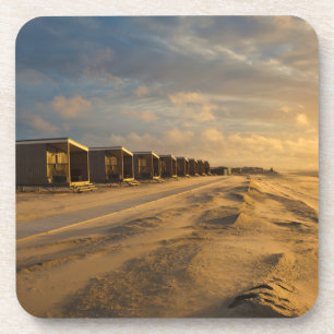 Beach cabins at sunset at the dutch coast coaster