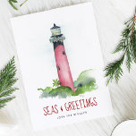 Beach Christmas Cards Watercolor Lighthouse<br><div class="desc">Celebrate Christmas and the 2025 holiday season with these beach Christmas cards featuring a hand-painted watercolor lighthouse inspired by the iconic Jupiter Inlet Lighthouse in Florida. This coastal lighthouse scene is decked out in festive garland and paired with the playful nautical greeting “Seas and Greetings” in a bold berry red...</div>