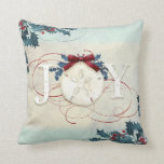 Beach Coastal Christmas Joy Sand Dollar Blue Holly Cushion<br><div class="desc">"Beach Coastal Christmas Joy Sand Dollar Holly with red glitter flourishes and a burgundy bow, throw pillow." Elegant watercolor design with a textured sand and sea background, holly in blue and red with the typography design, "JOY" in off white. Red glitter accents the calligraphy scrolls and a burgundy bow finishes...</div>