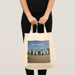 Beach huts blue skies sand english seaside tote bag