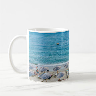 Beach lounge on seashore facing the sea coffee mug