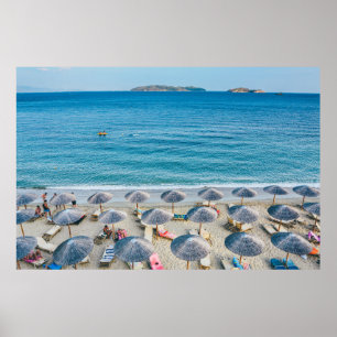 Beach lounge on seashore facing the sea poster