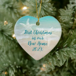 Beach New Home First Christmas Starfish Ceramic Ornament<br><div class="desc">First Christmas in a tropical / beach home ornament. Heart-shaped ceramic keepsake with text on both sides. Include the event with date on one side and names and address on the other. Aquamarine sea water and beach sand is the background for dark blue text. Two starfish also decorate each side....</div>