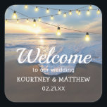 Beach Seaside String Lights Welcome Wedding Square Sticker<br><div class="desc">Romantic destination wedding welcome stickers featuring a coastal shoreline,  a beautiful sunset,  string lights,  and a modern text template that is easy to personalise.</div>