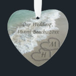 Beach Wedding Keepsake Interlocking Hearts Ornament<br><div class="desc">Elegant Sand Hearts written in the Beach nice to symbolise a Destination Wedding or tropical honeymoon travel vacation. Beautiful scenic image of clear aqua turquoise ocean water, with white waves crashing on the tan sand beach. Two interlocking hearts symbolise eternal love, even put your custom first or last name initials...</div>