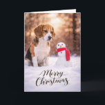 Beagle Christmas Snowman Card<br><div class="desc">A charming Christmas card featuring a Beagle sitting in fresh winter snow beside a cheerful little snowman wrapped in a red scarf. Warm golden winter light and softly falling snow create a peaceful holiday moment that perfectly captures the curiosity and gentle nature Beagles are known for. This card is perfect...</div>