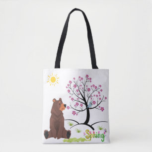 Bear observes the blooming tree and bird tote bag