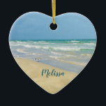 Beautiful Beach Photo Personalised Heart Christmas Ceramic Ornament<br><div class="desc">Beautiful heart shaped beach ornament with gorgeous seaside photography featuring a pretty sandpiper standing at the edge of the ocean waves on a sunny summer day. Lovely blue green water waves roll onto the sandy shore where your name is personalised in cute teal typography. A beautiful Christmas gift for a...</div>