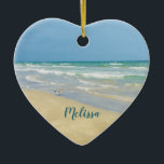 Beautiful Beach Photo Personalised Heart Christmas Ceramic Ornament<br><div class="desc">Beautiful heart shaped beach ornament with gorgeous seaside photography featuring a pretty sandpiper standing at the edge of the ocean waves on a sunny summer day. Lovely blue green water waves roll onto the sandy shore where your name is personalised in cute teal typography. A beautiful Christmas gift for a...</div>
