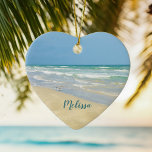Beautiful Beach Photo Personalised Heart Christmas Ceramic Ornament<br><div class="desc">Beautiful heart shaped beach ornament with gorgeous seaside photography featuring a pretty sandpiper standing at the edge of the ocean waves on a sunny summer day. Lovely blue green water waves roll onto the sandy shore where your name is personalised in cute teal typography. A beautiful Christmas gift for a...</div>