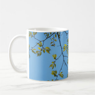 beautiful branch with green and yellow leaves hug coffee mug