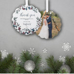 Beautiful Christmas Florals Wedding Thank You Tree Decoration Card<br><div class="desc">Pretty Christmas wedding thank you ornament personalised with your wedding photo on one side and on the other your shared last name with the year framed by pretty bouquets of Christmas flowers in white, red, blue, and green on the other side. Thank you wedding guests for sharing your special day...</div>