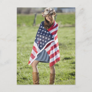 Beautiful cowgirl wrapped in American flag Postcard