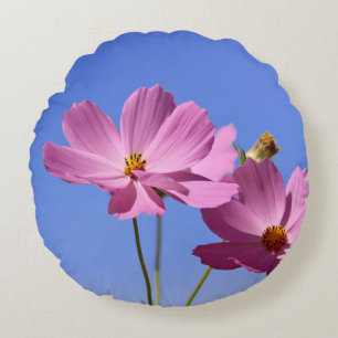 beautiful pink flowers hugging a clear blue sky round cushion