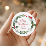 Beautiful Red & Green Watercolor Christmas Wreath Classic Round Sticker<br><div class="desc">A beautiful watercolor greenery and red berry wreath frames your message on this standout holiday sticker. The label tag has elegant typography,  and there is room to personalise.</div>