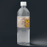 Beautiful Rustic Wood Barrel and Sunflowers Water Bottle Label<br><div class="desc">🥇AN ORIGINAL COPYRIGHT DESIGN by Donna Siegrist ONLY AVAILABLE ON ZAZZLE! Custom Wedding water bottle labels ready for you to personalise. Featured in a country barn wood setting with mason jars and string lights hanging over a bale of straw hay, a wagon wheel and beautiful yellow sunflowers. 📌If you need...</div>