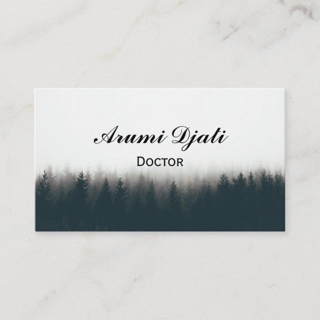Beautiful shot of a thick forest in fog with pine  business card (Front)
