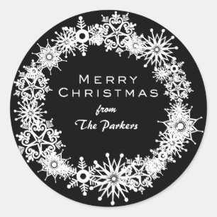 Beautiful snowflakes on a black background classic round sticker