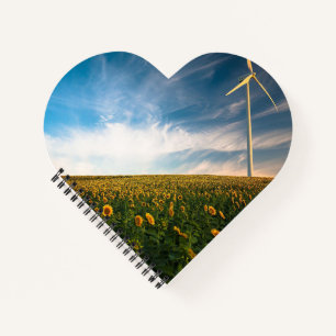 beautiful sun flowers field with cloudy blue sky a notebook