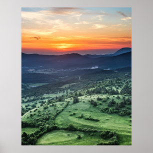 Beautiful sunset behind green fields poster