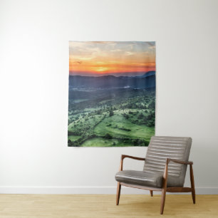 Beautiful sunset behind green fields tapestry