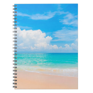 Beautiful tropical beach with blue sky and white c notebook