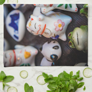Beckoning cat figurines tea towel