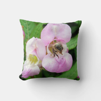 Bee emerging from a sweet pea flower cushion