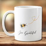 Bee Grateful  Coffee Mug<br><div class="desc">This coffee mug is decorated with watercolor honey bees and "Bee Grateful" in stylish script typography.
Easily customisable with your monogram.
Original Watercolor © Michele Davies.</div>