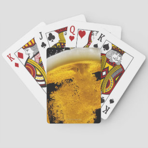 Beer been poured into glass playing cards