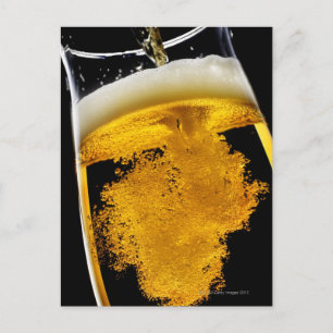 Beer been poured into glass postcard