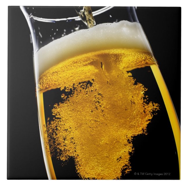 Beer been poured into glass, studio shot ceramic tile (Front)