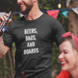 Beers Bags and Boards Corn Hole Game T-Shirt<br><div class="desc">This design may be personalised in the area provided by changing the photo and/or text. Or it can be customised by clicking Personalise this Template and then choosing the click to customise further option and delete or change the colour of the background, add text, change the text colour or style,...</div>