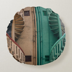 Beige and green concrete spiral stairs beside buil round cushion