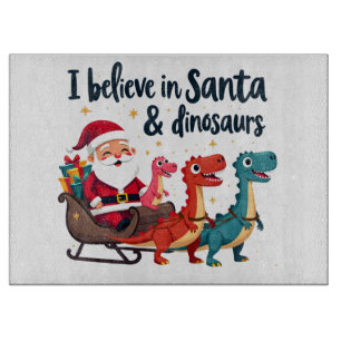 believe in Santa and dinosaurs (Santa riding dinos Cutting Board