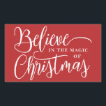 Believe in the magic of Christmas red Rectangular Sticker<br><div class="desc">Modern holiday greeting sticker featuring the wordings "Believe in the magic of Christmas" over a festive red background.</div>