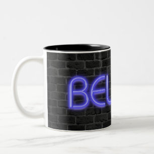 Believe text in neon lights on brick Two-Tone coffee mug