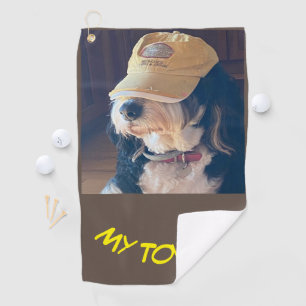 Bernedoodle dog in yellow golf cap photo  towel