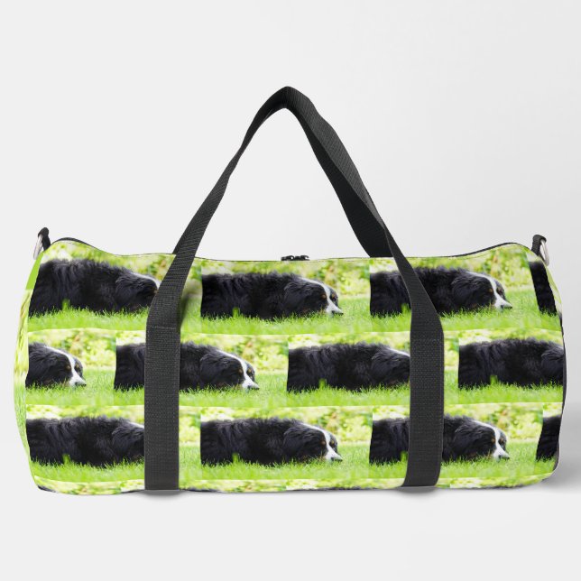 bernese mountain dog laying in grass duffle bag (Front)
