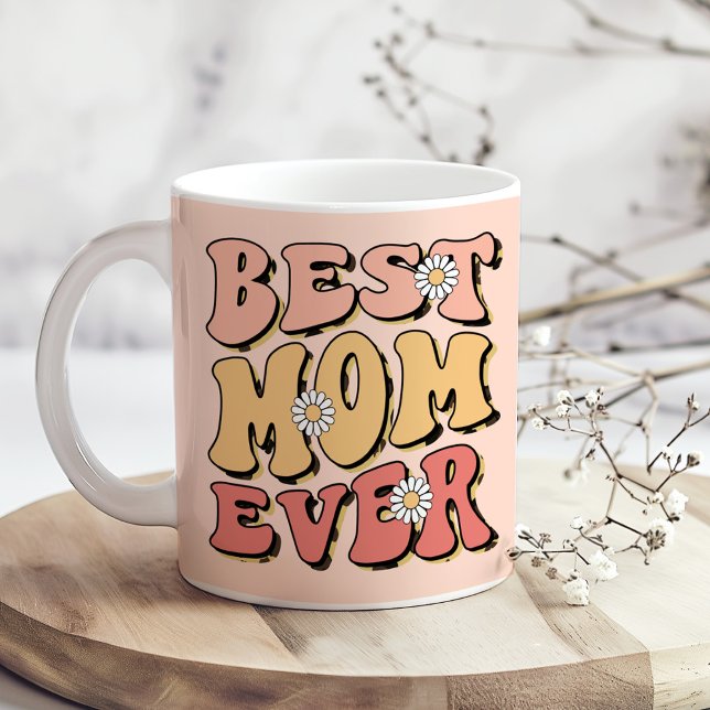 "Best Mum Ever" Retro Blush Pink White Daisy  Coffee Mug ("Best Mom Ever" Retro Blush Pink White Daisy Coffee Mug on a sunny boho wooden kitchen table)