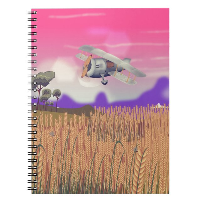Bi-Plane Flying over crops under setting sun Notebook (Front)