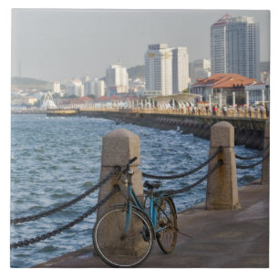 Bicycle at waterfront with Yantai city skyline, Tile