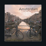 Bicycles at sunset in Amsterdam Magnet<br><div class="desc">Souvenir photo magnet with some bicycles locked to the bar of a bridge over Prinsengracht canal lined by traditional canal houses at sunset in the city centre of Amsterdam in the Netherlands with the text 'Amsterdam,  The Netherlands'.</div>