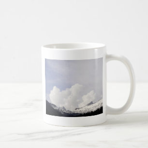 Big white clouds over the mountains coffee mug