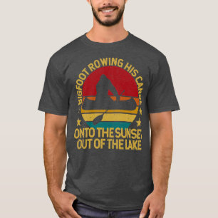 Bigfoot rowing his canoe into the sunset T-Shirt