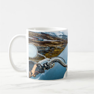 Biker rides a motorcycle on a slippery road throug coffee mug