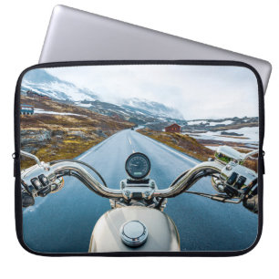 Biker rides a motorcycle on a slippery road throug laptop sleeve