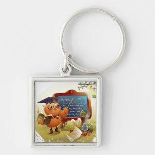 Bird holding a book and teaching at a blackboard key ring