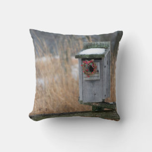 Bird, nest box with holiday wreath in winter cushion