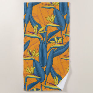 Bird of paradise flowers on orange beach towel
